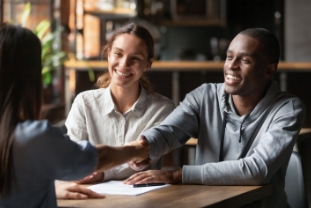 Happy interracial couple handshake